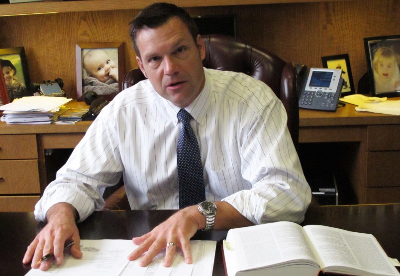 In this Friday, Sept. 12, 2014 photo, Kansas Secretary of State Kris Kobach discusses his office's legal research for an elections case before the state Supreme Court during an interview in his office in Topeka, Kan. Democrat Chad Taylor has petitioned the Supreme Court to remove his name from the ballot for the U.S. Senate after Kobach refused to do it. (AP Photo/John Hanna)
