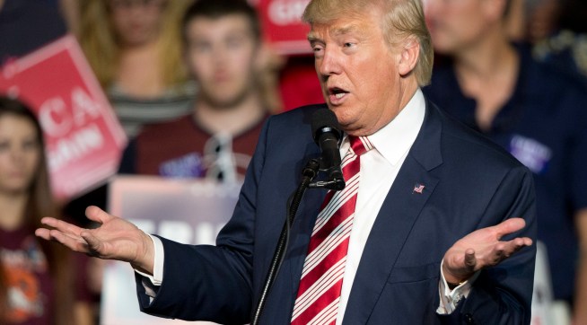 HOLD FOR STORY - FILE – In this Sept. 24, 2016, file photo, Republican presidential candidate Donald Trump gestures during a rally in Roanoke, Va. Countless former Democrats in Ohio's blue-collar Mahoning Valley are transferring their adoration for late U.S. Rep. James Traficant, D-Ohio, to Republican presidential nominee Donald Trump, while those who knew Traficant say similarities to Trump end at the populist bravado and outsized hair. (AP Photo/Steve Helber, File)