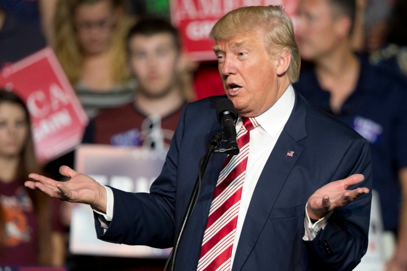 HOLD FOR STORY - FILE – In this Sept. 24, 2016, file photo, Republican presidential candidate Donald Trump gestures during a rally in Roanoke, Va. Countless former Democrats in Ohio's blue-collar Mahoning Valley are transferring their adoration for late U.S. Rep. James Traficant, D-Ohio, to Republican presidential nominee Donald Trump, while those who knew Traficant say similarities to Trump end at the populist bravado and outsized hair. (AP Photo/Steve Helber, File)
