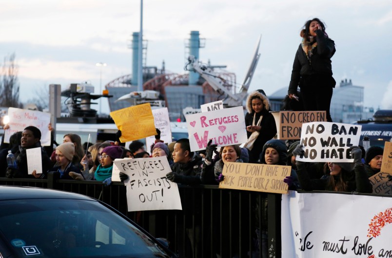 Protesters rally in front of John F. Kennedy International Airport in New York, Sunday, Jan. 29, 2017. (AP Photo/Seth Wenig)