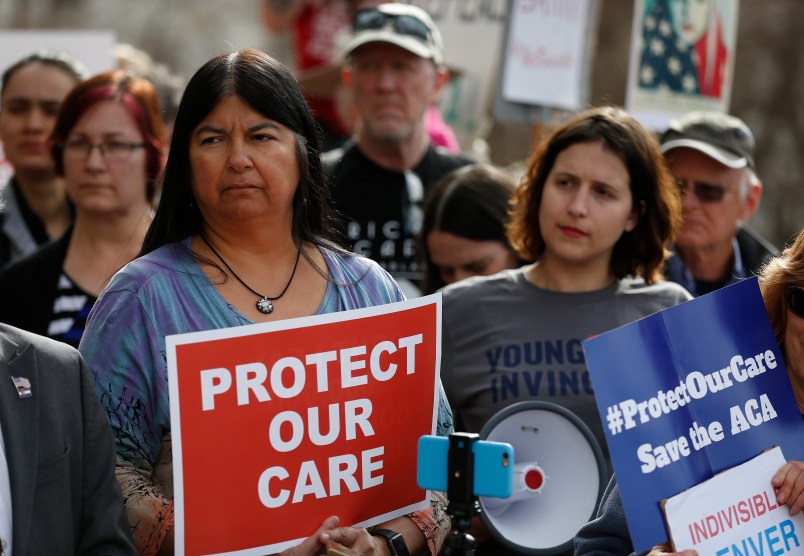 State Sen. Dr. Irene Aguilar, D-Denver, left, stands with activist Christina Postolowski, of the group Young Invincibles, as supporters of the Affordable Care Act who are also opponents of Colorado's GOP-led plan to undo Colorado's state-run insurance exchange hold a rally on the state Capitol steps in Denver, Tuesday, Jan. 31, 2017. The state GOP measure, a bill which would dismantle Connect For Health Colorado within a year, is an indication of how Republicans plan to chip away at Obamacare. If the federal health care law remains unchanged, it would force Coloradans shopping for private insurance to use the federal exchange. (AP Photo/Brennan Linsley)