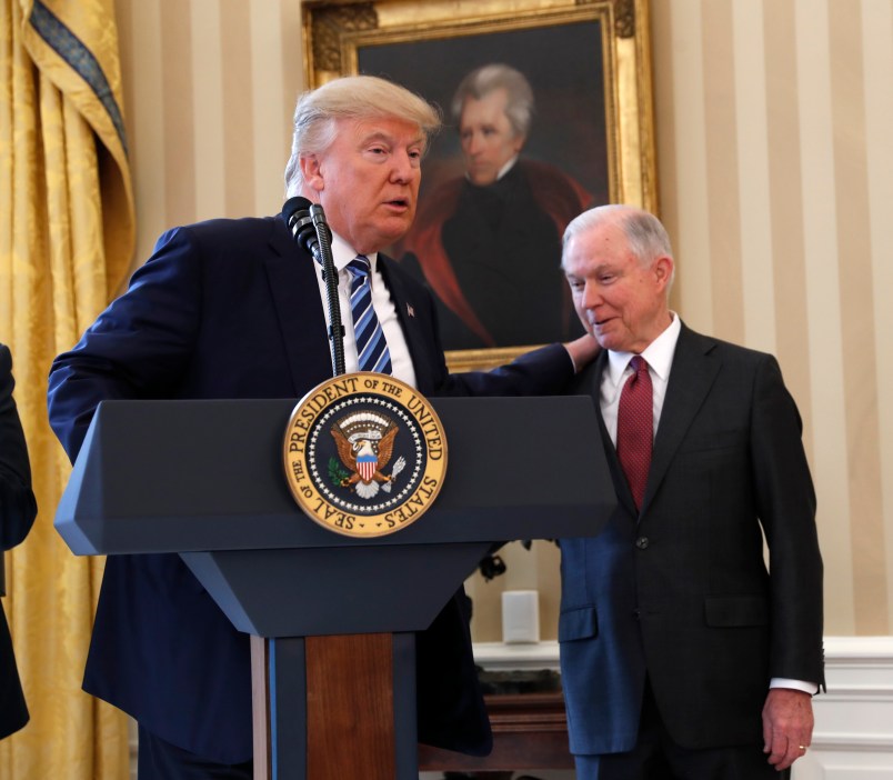 President Donald Trump watches as Vice President Mike Pence administers the oath of office to Attorney General Jeff Sessions, accompanied by his wife Mary, Thursday, Feb. 9, 2017, in the Oval Office of the White House in Washington. (AP Photo/Pablo Martinez Monsivais)