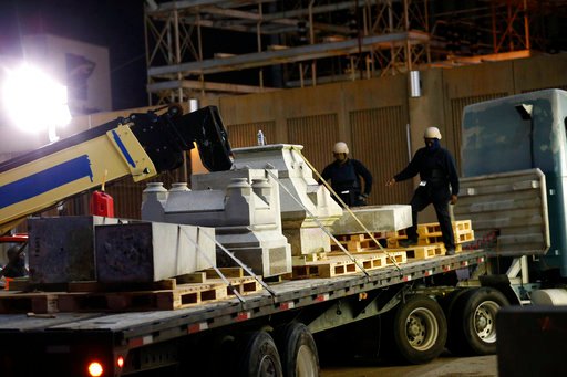 Workers dismantle the Liberty Place monument, one that commemorates whites who tried to topple a biracial post-Civil War government, in New Orleans Monday, April 24, 2017. It was removed overnight in an attempt to avoid disruption from supporters who want the monuments to stay, some of whom city officials said have made death threats. (AP Photo/Gerald Herbert)