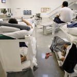** ATTENTION HOLD FOR GRAHAM MORRISON ** Detainees are shown resting on bunks inside the "B" cell and bunk unit of the Northwest Detention Center in Tacoma, Wash. Friday, Oct. 17, 2008. The facility is operated by The GEO Group Inc. under contract from U.S. Immigrations and Customs Enforcement, and houses people whose immigration status is in question or who are waiting for deportation or deportation hearings. (AP Photo/Ted S. Warren)