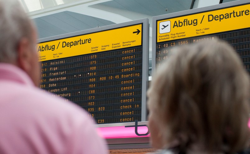 Passengers stand in front of the annunciator panel as all flights are canceled at Tegel Airport in Berlin, Germany, Wednesday, May 25, 2011. Hundreds of flights flights were canceled in Europe as winds blew the cloud of ash from the Grimsvotn volcano over parts of northern Europe. Experts say that particles in the ash could stall jet engines and sandblast planes' windows. (AP Photo/Gero Breloer)