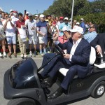 Republican presidential candidate Donald Trump drives himself around the golf course to watch the final round of the Cadillac Championship golf tournament, Sunday, March 6, 2016, in Doral, Fla. (AP Photo/Luis Alvarez)