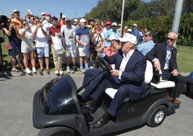 Republican presidential candidate Donald Trump drives himself around the golf course to watch the final round of the Cadillac Championship golf tournament, Sunday, March 6, 2016, in Doral, Fla. (AP Photo/Luis Alvarez)