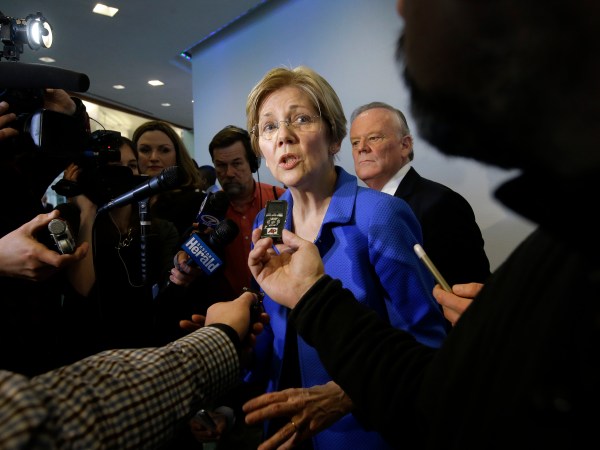 U.S. Sen. Elizabeth Warren, D-Mass., center, takes question from members of the media after addressing business leaders during a New England Council luncheon at a hotel, Monday, March 27, 2017, in Boston. (AP Photo/Steven Senne)
