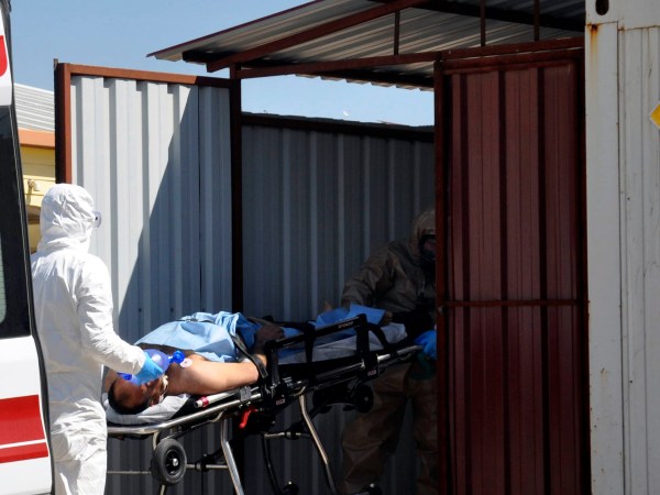 A Turkish expert evacuateS a victim of alleged chemical weapons attacks in Syrian city of Idlib, at a local hospital in Reyhanli, Hatay, Turkey, Tuesday, April 4, 2017. A suspected chemical attack in a town in Syria's rebel-held northern Idlib province killed dozens of people on Tuesday, opposition activists said, describing the attack as among the worst in the country's six-year civil war. (DHA-Depo Photos via AP)