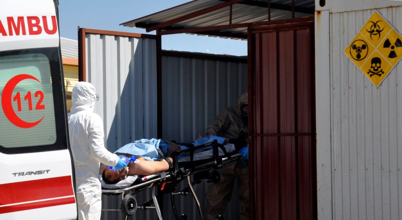 A Turkish expert evacuateS a victim of alleged chemical weapons attacks in Syrian city of Idlib, at a local hospital in Reyhanli, Hatay, Turkey, Tuesday, April 4, 2017. A suspected chemical attack in a town in Syria's rebel-held northern Idlib province killed dozens of people on Tuesday, opposition activists said, describing the attack as among the worst in the country's six-year civil war. (DHA-Depo Photos via AP)