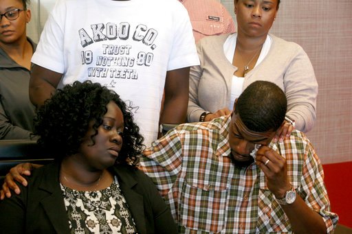 Odell Edwards wipes away tears as he sits with his wife, Charmaine Edwards, listenintg to their attorney Lee Merritt talking about the death of their son, Jordan Edwards, in a police shooting Saturday in Balch Springs, Texas in Merritt's law office in Dallas Monday, May 1, 2017.