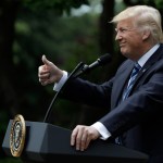 President Donald Trump signs an executive order aimed at easing an IRS rule limiting political activity for churches, in the Rose Garden of the White House, Thursday, May 4, 2017, in Washington. (AP Photo/Evan Vucci)