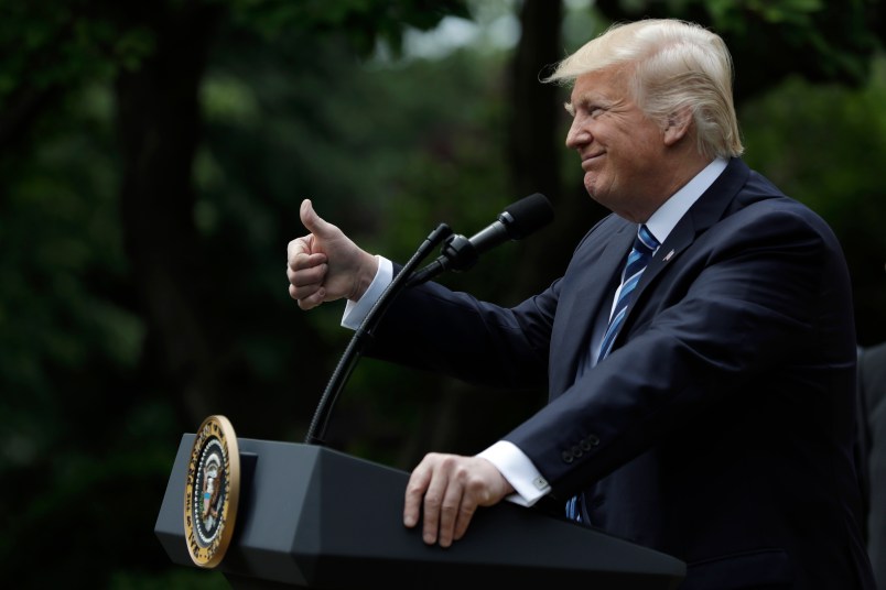 President Donald Trump signs an executive order aimed at easing an IRS rule limiting political activity for churches, in the Rose Garden of the White House, Thursday, May 4, 2017, in Washington. (AP Photo/Evan Vucci)