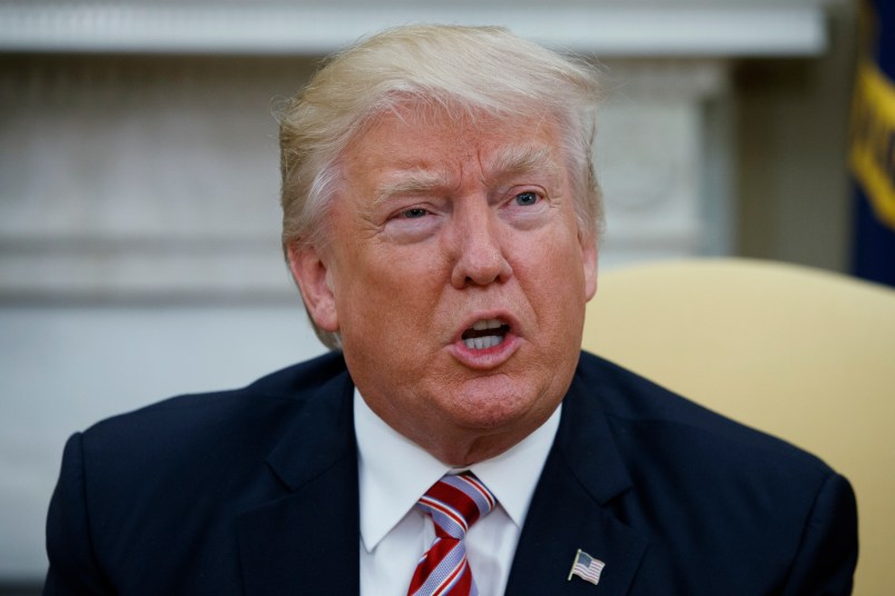 President Donald Trump talks to reporters during a meeting with former Secretary of State Henry Kissinger in the Oval Office of the White House, Wednesday, May 10, 2017, in Washington. (AP Photo/Evan Vucci)