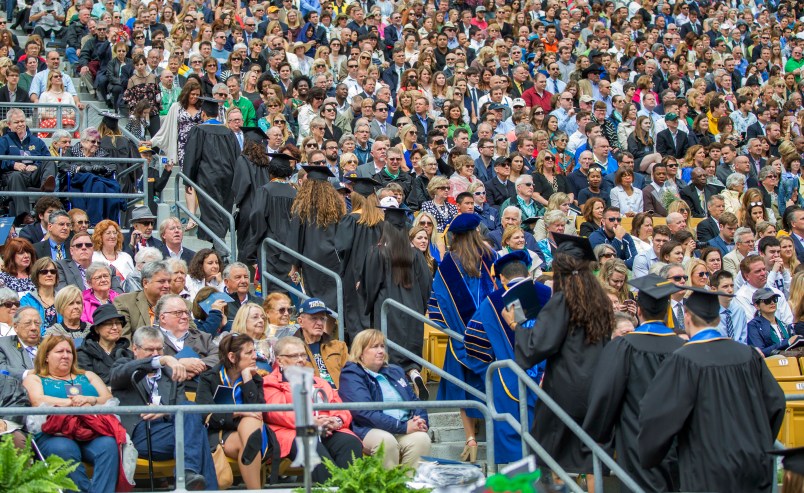 Notre Dame graduates walk out of Notre Dame Stadium in protest as Vice President Mike Pence begins to speak for the 2017 commencement ceremony Sunday, May 21, 2017, in South Bend, Ind. (Robert Franklin/South Bend Tribune via AP)