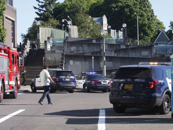 Police investigate a deadly stabbing on a MAX train in Northeast Portland, Ore., Friday, May 26, 2017. (Jim Ryan/The Oregonian via AP)