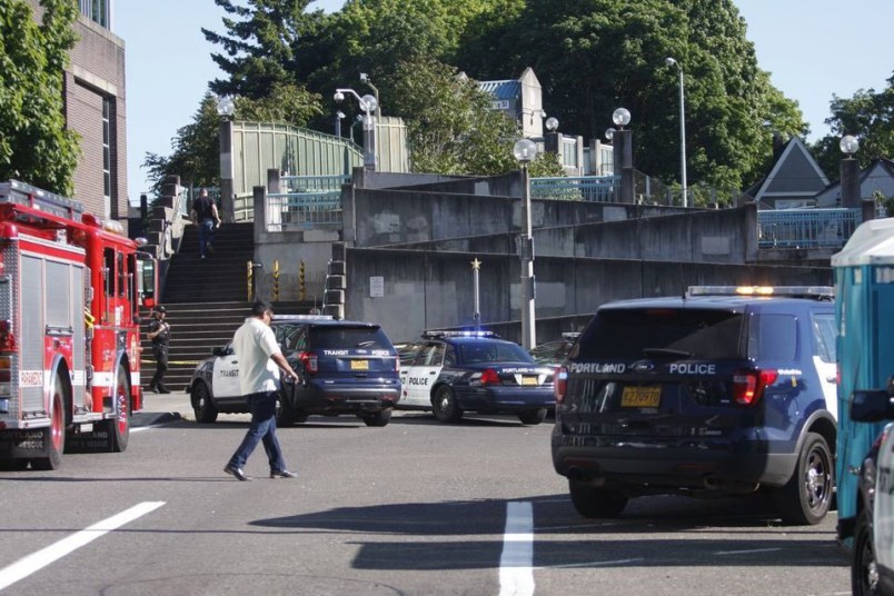 Police investigate a deadly stabbing on a MAX train in Northeast Portland, Ore., Friday, May 26, 2017. (Jim Ryan/The Oregonian via AP)