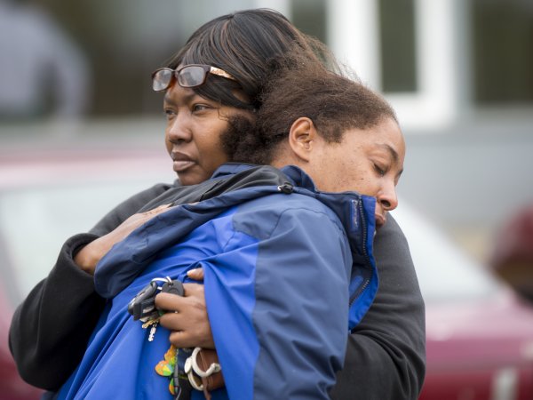 A family member comforts Monika Williams, front, after an officer-involved shooting killed her sister at the Brettler Family Place Apartments at Magnuson Park Sunday June 18, 2017. According to police, two officers responded to a burglary call made by the woman, who they say brandished a knife at some point, and both officers shot her dead in her apartment. Children were home at the time, but physically unharmed. â€œThereâ€™s no reason for her to be shot in front of her babies,â€ Williams yelled to reporters when she arrived on scene. â€œThe Seattle police shot the wrong one today.â€ OUTS: SEATTLE OUT, USA TODAY OUT, MAGAZINES OUT, ONLINE OUT, TELEVISION OUT, SALES OUT. MANDATORY CREDIT TO: Bettina Hansen / THE SEATTLE TIMES.