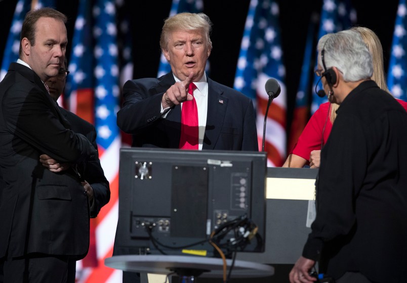Republican presidential candidate Donald Trump, center, talks with production crew during a walk through in preparation for his speech at the Republican National Convention, Thursday, July 21, 2016, in Cleveland. (AP Photo/Evan Vucci)