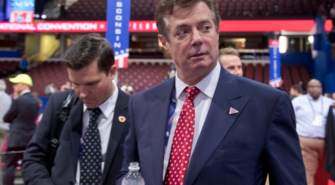 FILE - In this July 18, 2016, file photo, Trump campaign chairman Paul Manafort walks around the convention floor before the opening session of the Republican National Convention in Cleveland. Hillary Clinton’s campaign is questioning Donald Trump’s top political aide’s ties to a pro-Kremlin political party in Ukraine, claiming it is evidence of the Republican nominee’s cozy relationship with Russia. The New York Times reported that handwritten ledgers found in Ukraine show $12.7 million in undisclosed payments to Paul Manafort from the pro-Russia party founded by the country’s former president Viktor Yanukovych. (AP Photo/Carolyn Kaster, File)