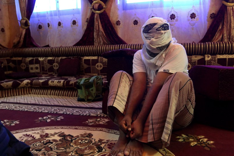 In this May 11 2017 photo, a former detainee speaks after covering his face for fear of detention. He recounted the torment he suffered in Riyan prison where hundreds of terror suspects are held without trial after being rounded up by local Yemeni forces loyal to the United Arab Emiratis in the southern city of Mukalla. Former detainees report brutal torture, and families search desperately for loved ones who have disappeared. Some including have been flown to ships in the sea and an Emirati base in the nearby Horn of Africa. (AP Photo/Maad El Zikry)