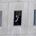 An armed man stands in a window of the parliament building in Tehran, Iran, Wednesday, June 7, 2017. Several attackers stormed into Iran's parliament and a suicide bomber targeted the shrine of Ayatollah Ruhollah Khomeini on Wednesday, killing a security guard and wounding several other people in rare twin attacks, with the shooting at the legislature still underway. (Fars News Agency, Omid Vahabzadeh via AP)