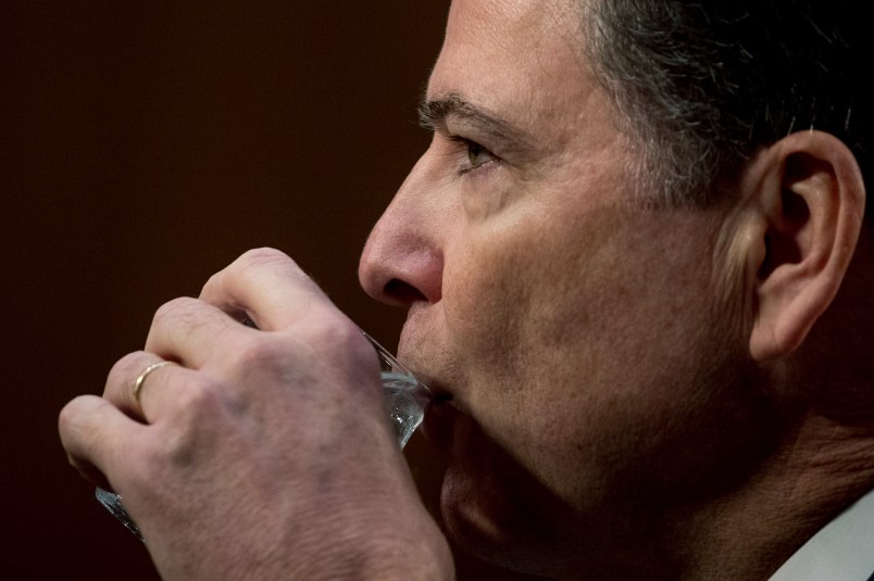 Former FBI Director James Comey takes a drink of water as he testifies at a Senate Intelligence Committee hearing on Capitol Hill, Thursday, June 8, 2017, in Washington. (AP Photo/Andrew Harnik)