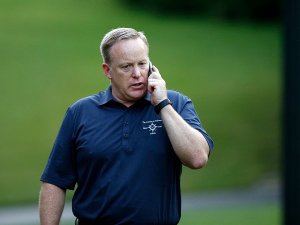 White House Press Secretary Sean Spicer talks on a phone during the Congressional Picnic on the South Lawn of the White House, Thursday, June 22, 2017, in Washington. (AP Photo/Alex Brandon)