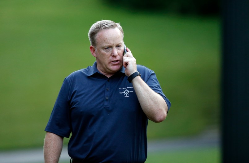 White House Press Secretary Sean Spicer talks on a phone during the Congressional Picnic on the South Lawn of the White House, Thursday, June 22, 2017, in Washington. (AP Photo/Alex Brandon)