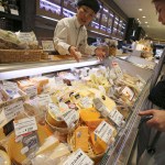 WAIT FOR A STORY; A customer looks at imported cheese at department store in Tokyo, Saturday, July 1, 2017. (AP Photo/Koji Sasahara)