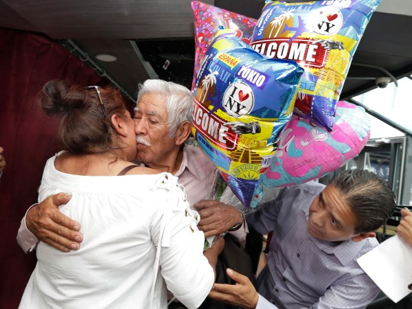 Luis Mendes Chanes, center, is reunited with his daughter Marta Mendez and her husband Luis Flores, of Queens, N.Y., aboard the Bateaux New York, in New York,  Wednesday, July 5, 2017. She had not seen him in 24 years. (AP Photo/Richard Drew)