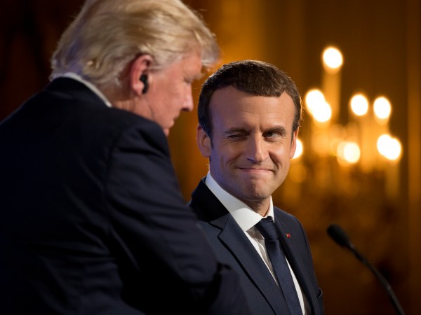 French President Emmanuel Macron winks at President Donald Trump during a joint news conference at the Elysee Palace in Paris, Thursday, July 13, 2017. (AP Photo/Carolyn Kaster)