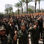 Officers from Hamas national security force chant Islamic slogans while holding their rifles up during a parade against Israeli arrangements in the contested Jerusalem shrine, in front of the Palestinian Legislative Council in Gaza City, Wednesday, July 26, 2017. A senior Muslim official in Jerusalem said Wednesday that worshippers would not return to the contested shrine until Israel removes the new railings and cameras it installed after a deadly attack there. (AP Photo/Adel Hana)