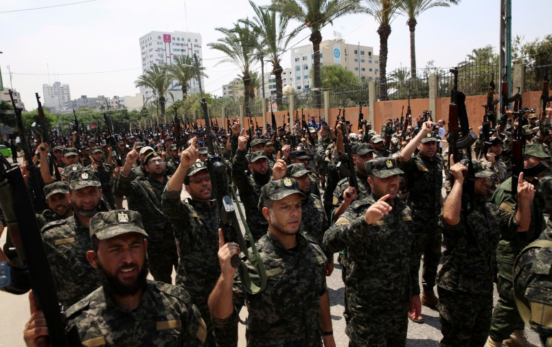 Officers from Hamas national security force chant Islamic slogans while holding their rifles up during a parade against Israeli arrangements in the contested Jerusalem shrine, in front of the Palestinian Legislative Council in Gaza City, Wednesday, July 26, 2017. A senior Muslim official in Jerusalem said Wednesday that worshippers would not return to the contested shrine until Israel removes the new railings and cameras it installed after a deadly attack there. (AP Photo/Adel Hana)