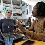 Xonjenese Jacobs, right, helps Kristen Niemi sign up for the Affordable Care Act during a healthcare expo at the University of South Florida Tuesday, Jan. 24, 2017, in Tampa, Fla. (AP Photo/Chris O'Meara)