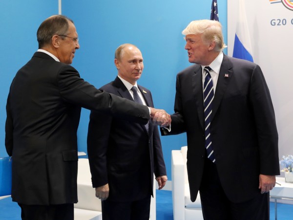 U.S. President Donald Trump, right, greets Russian Foreign Minister Sergey Lavrov, left, prior his talks with Russian President Vladimir Putin, center, during the G20 summit in Hamburg Germany, Friday July 7, 2017. (Mikhail Klimentyev, Kremlin Pool Photo via AP)