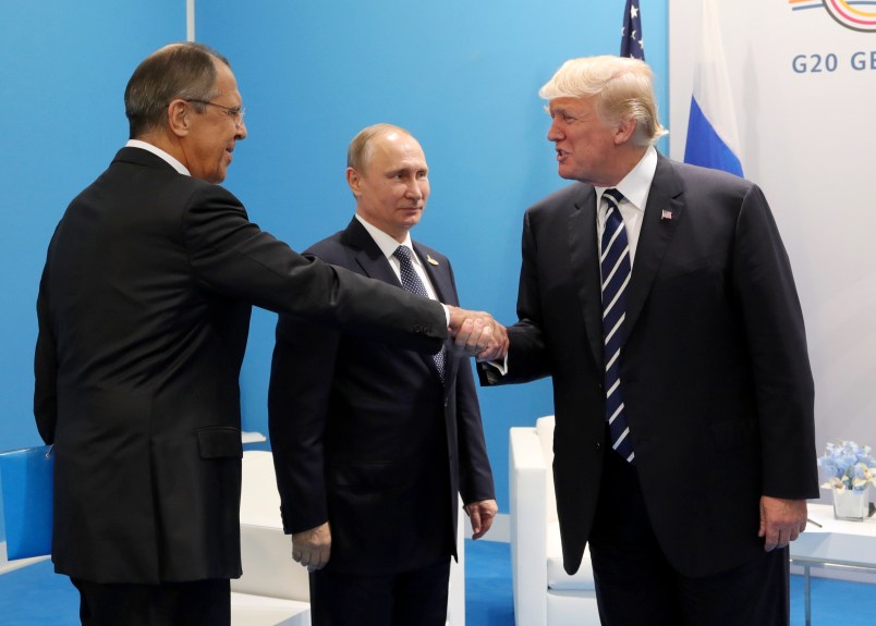 U.S. President Donald Trump, right, greets Russian Foreign Minister Sergey Lavrov, left, prior his talks with Russian President Vladimir Putin, center, during the G20 summit in Hamburg Germany, Friday July 7, 2017. (Mikhail Klimentyev, Kremlin Pool Photo via AP)