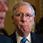 Senate Majority Leader Mitch McConnell, R-Ky., listens to remarks by Sen. John Barrasso, R-Wyo., as they meet with reporters after a closed-door Republican strategy session, on Capitol Hill in Washington, Tuesday, July 11, 2017. McConnell says Senate Republicans will unveil their revised health care bill Thursday and begin voting on it next week, adding, he could delay the chamber's August recess for two weeks as the GOP tries breaking logjams that have slowed work on that and other issues.   (AP Photo/J. Scott Applewhite)