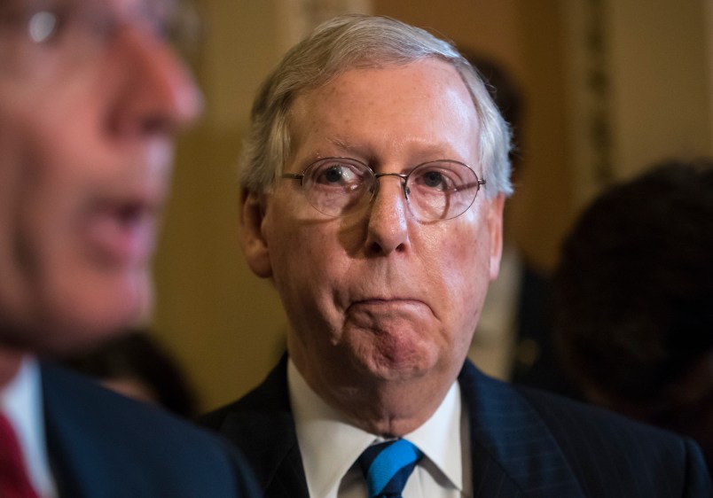 Senate Majority Leader Mitch McConnell, R-Ky., listens to remarks by Sen. John Barrasso, R-Wyo., as they meet with reporters after a closed-door Republican strategy session, on Capitol Hill in Washington, Tuesday, July 11, 2017. McConnell says Senate Republicans will unveil their revised health care bill Thursday and begin voting on it next week, adding, he could delay the chamber's August recess for two weeks as the GOP tries breaking logjams that have slowed work on that and other issues.   (AP Photo/J. Scott Applewhite)