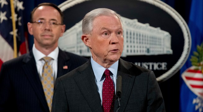 Attorney General Jeff Sessions accompanied by Deputy Attorney General Rod Rosenstein, left, speaks at a news conference to announce an international cybercrime enforcement action at the Department of Justice, Thursday, July 20, 2017, in Washington. (AP Photo/Andrew Harnik)