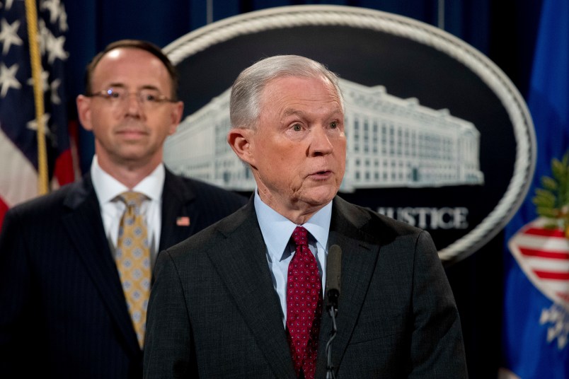 Attorney General Jeff Sessions accompanied by Deputy Attorney General Rod Rosenstein, left, speaks at a news conference to announce an international cybercrime enforcement action at the Department of Justice, Thursday, July 20, 2017, in Washington. (AP Photo/Andrew Harnik)