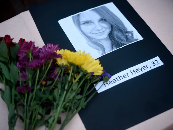 A portrait of Heather Heyer, who was killed when a vehicle drove through counter protestors in Charlottesville, Va., lies on on a table with flowers at the Vigil Against Hate held on the campus of the University of Southern Mississippi in solidarity with the counter protesters killed and injured against the White Nationalists in Charlottesville, Va., in Hattiesburg, Miss. Monday, Aug 14, 2017 (Courtland Wells | Vicksburg Post, via AP)