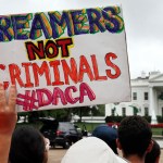 A woman holds up a signs in support of the Obama administration program known as Deferred Action for Childhood Arrivals, or DACA, during an immigration reform rally, Tuesday, Aug. 15, 2017, at the White House in Washington. The Trump administration has said it still has not decided the program's fate. (AP Photo/Jacquelyn Martin)
