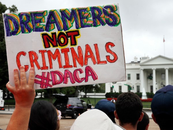 A woman holds up a signs in support of the Obama administration program known as Deferred Action for Childhood Arrivals, or DACA, during an immigration reform rally, Tuesday, Aug. 15, 2017, at the White House in Washington. The Trump administration has said it still has not decided the program's fate. (AP Photo/Jacquelyn Martin)