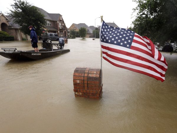 Volunteers use their boat to help evacuate residents as floodwaters from Tropical Storm Harvey rise Monday, Aug. 28, 2017, in Spring, Texas. (AP Photo/David J. Phillip)