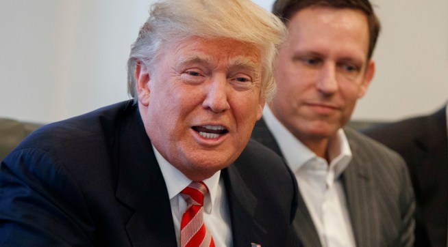 Apple CEO Tim Cook, right, and PayPal founder Peter Thiel, center, listen as President-elect Donald Trump speaks during a meeting with technology industry leaders at Trump Tower in New York, Wednesday, Dec. 14, 2016. (AP Photo/Evan Vucci)