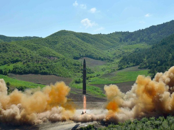 FILE- In this July 4, 2017, file photo distributed by the North Korean government shows what was said to be the launch of a Hwasong-14 intercontinental ballistic missile, ICBM, in North Korea's northwest. North Korea has been condemned and sanctioned for its nuclear ambitions, yet has still received food, fuel and other aid from its neighbors and adversaries for decades. How does the small, isolated country keep getting what it wants and needs to prevent its collapse?(Korean Central News Agency/Korea News Service via AP, File)