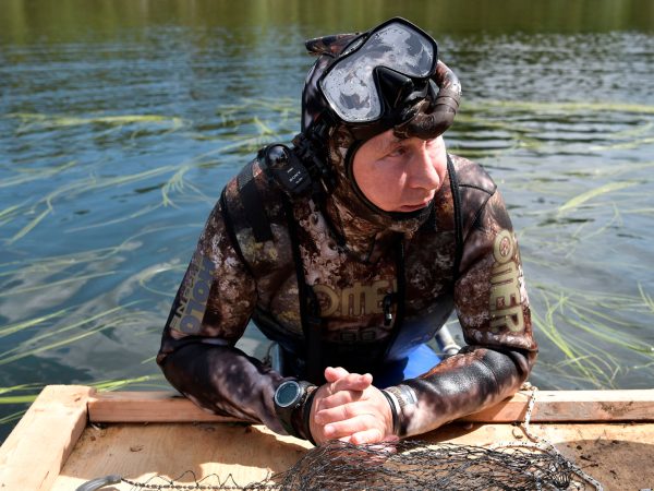 In this photo released by Kremlin press service on Saturday, Aug.  5, 2017, Russian President Vladimir Putin prepares to swim while fishing during a mini-break in the Siberian Tyva region, a few days ago. (Alexei Nikolsky, Sputnik, Kremlin Pool Photo via AP)