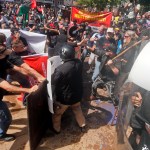 Alt Right demonstrators clash with  counter demonstrators at the entrance to Lee Park in Charlottesville, Va., Saturday, Aug. 12, 2017.  (AP Photo/Steve Helber)