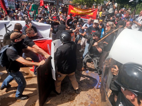 Alt Right demonstrators clash with  counter demonstrators at the entrance to Lee Park in Charlottesville, Va., Saturday, Aug. 12, 2017.  (AP Photo/Steve Helber)